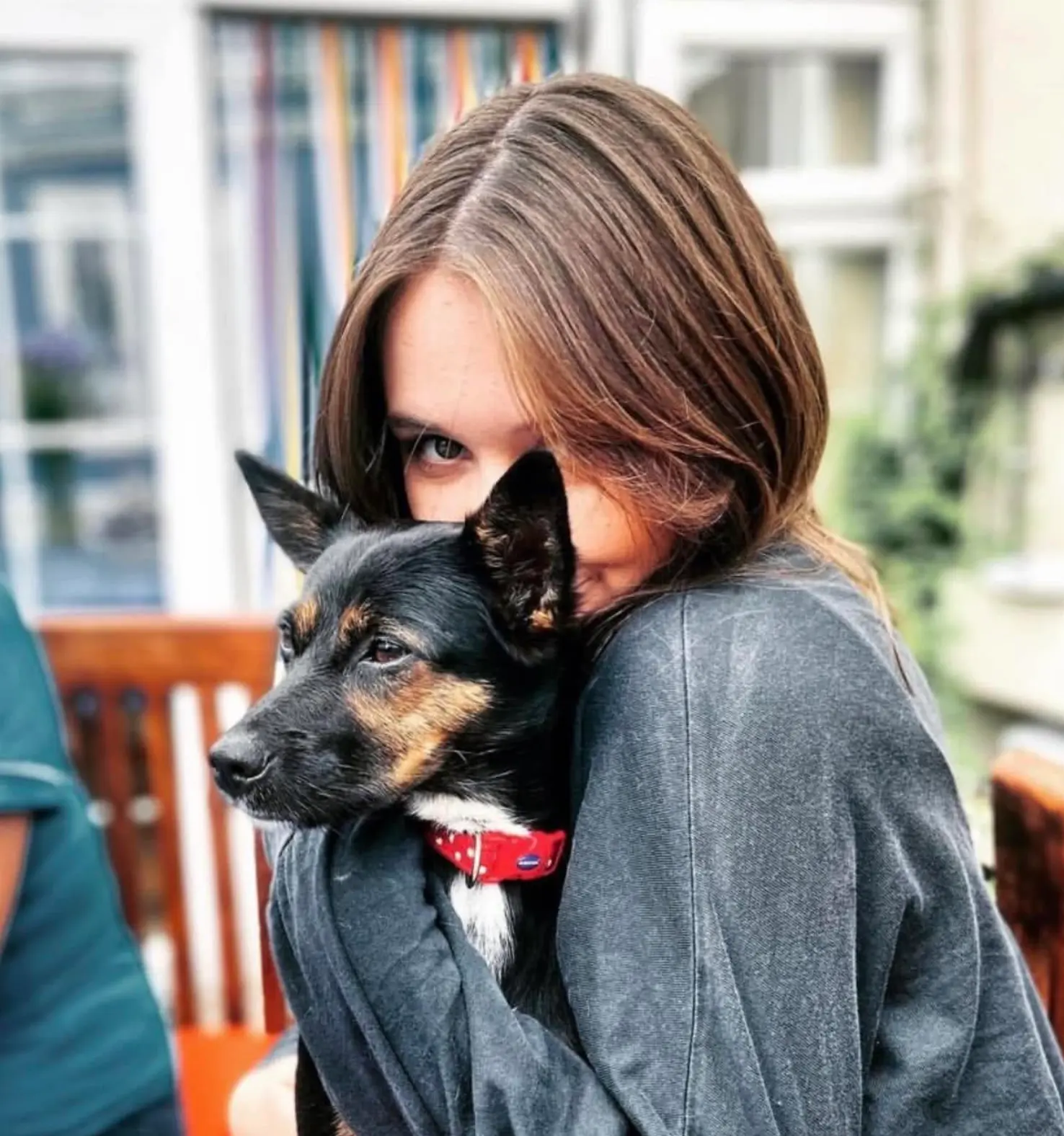 Georgie hugging a happy dog